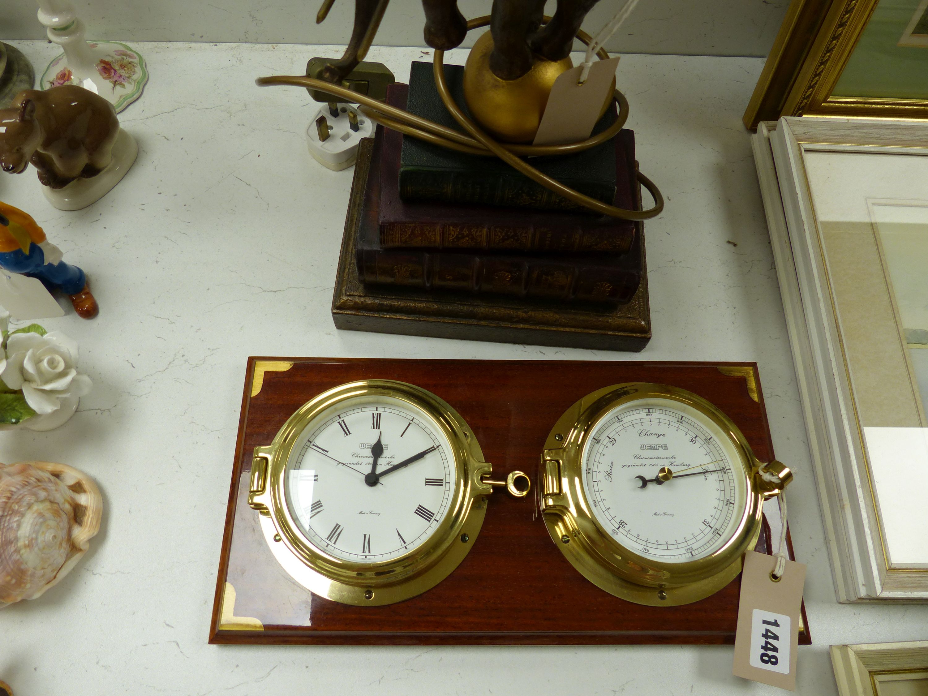 A Wempe wall-mounted ship's style clock/barometer and an 'elephant on books' table lamp
